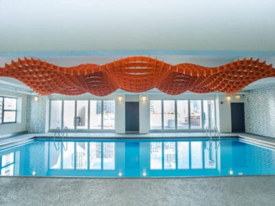 acoustic-design-installation-above-filled-swimming-pool acoustic ceiling design spans the length of the pool