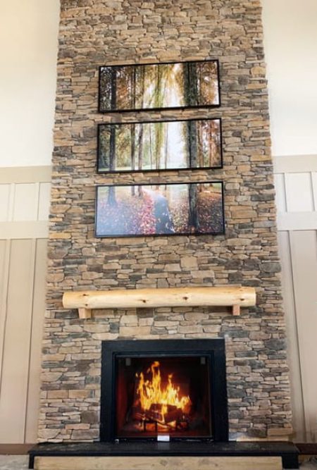 artwork installed above a fireplace