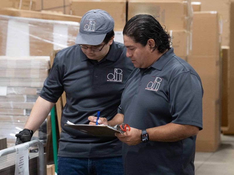 two employees managing furniture inventory in the warehouse